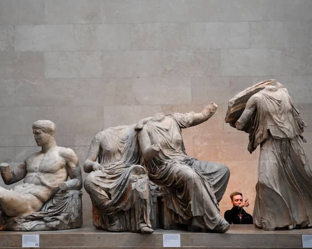 Visitors view the Parthenon Marbles, also known as the Elgin Marbles, at the British Museum in London