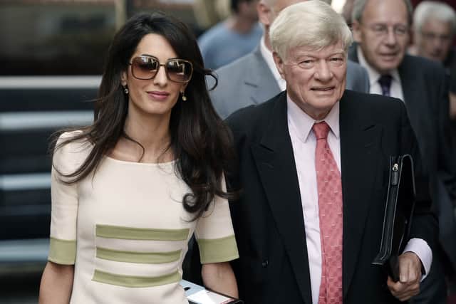 Human rights lawyer Amal Alamuddin Clooney and head of Doughty Street Chambers Geoffrey Robertson arrive at the ministry of culture and sports in Athens on October 14, 2014