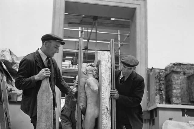 Workmen wheeling a 'metope', a carved marble square, into the Elgin gallery at the British Museum in London, May 1949.