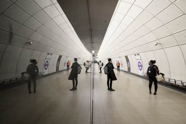 Members of the media and staff stand on the near-empty platform in the new Elizabeth Line section of Farringdon station ahead of the planned opening date, on May 19, 2022