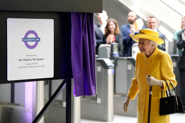 Queen Elizabeth II unveils a plaque to mark the official opening of the 'Elizabeth Line' rail service at Paddington Station in London on May 17, 2022