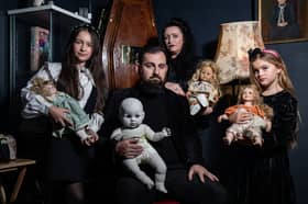 JP Kennedy and Kymmi Jeffery with daughters Snow and Pebble (L-R), known as The Occult Family, holding haunted dolls inside their haunted room.