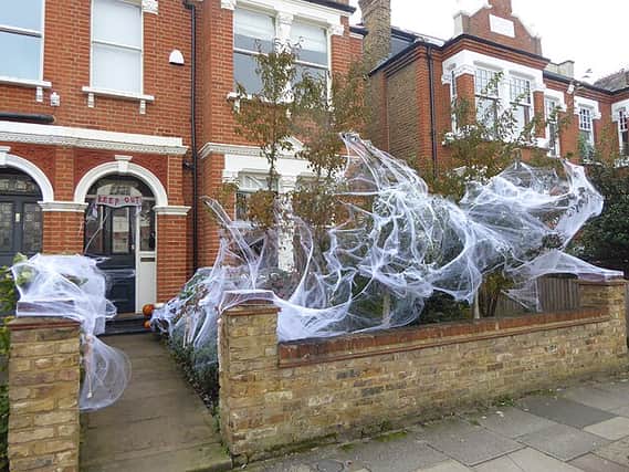 Spooky spider webs outside a house in Putney