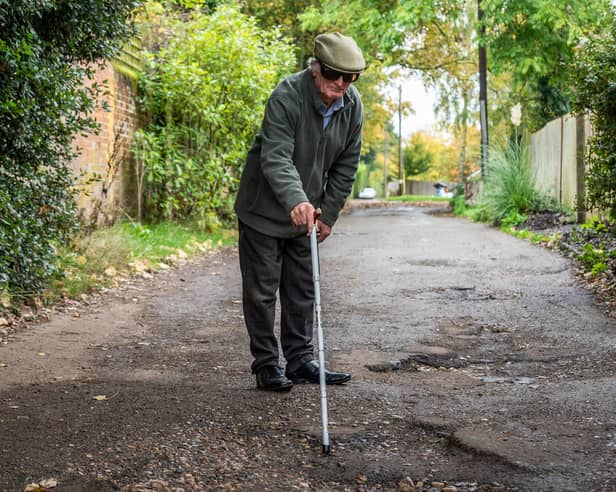Furious resident Douglas Debnam on Whitebarns Lane in the village of Furneaux Phelham in Hertfordshire, is embroiled in Britain's longest running pothole row.