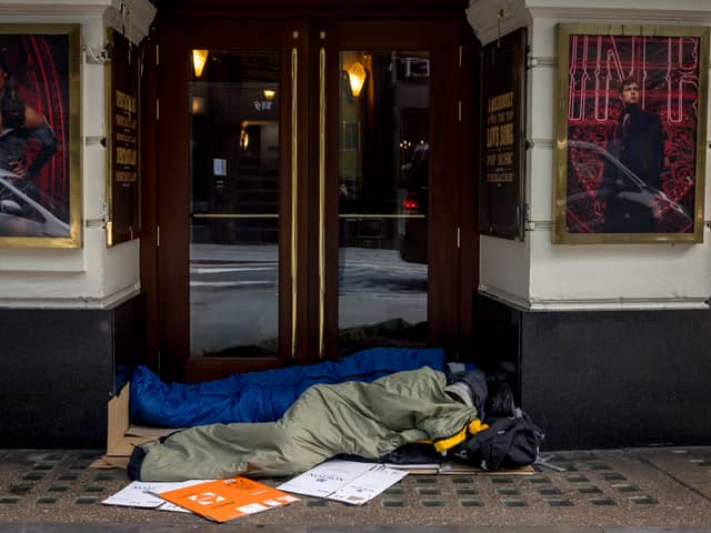 Two homeless people lie in sleeping bags in the doorway of a theatre on October 24, 2024 in London, England. Data released earlier this year revealed that the number of people rough sleeping in London between January to March 2024 rose by 33 percent to 4118 year on year. 