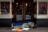 Two homeless people lie in sleeping bags in the doorway of a theatre on October 24, 2024 in London, England. Data released earlier this year revealed that the number of people rough sleeping in London between January to March 2024 rose by 33 percent to 4118 year on year. 