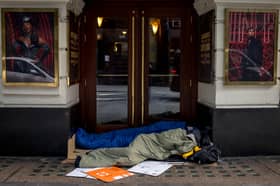 Two homeless people lie in sleeping bags in the doorway of a theatre on October 24, 2024 in London, England. Data released earlier this year revealed that the number of people rough sleeping in London between January to March 2024 rose by 33 percent to 4118 year on year. 