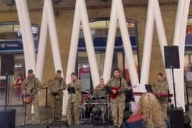 British Legion band performs beneath the giant poppy at Kings Cross
