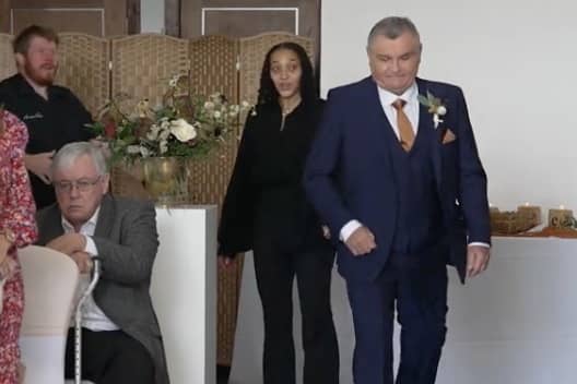 Neil Crossley walks down the aisle at his daughter's wedding, forgetting to take her with him.