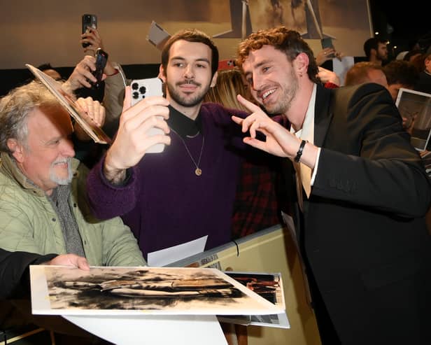 Paul Mescal takes photos with fans in the crowd at the premiere of Gladiator II in London