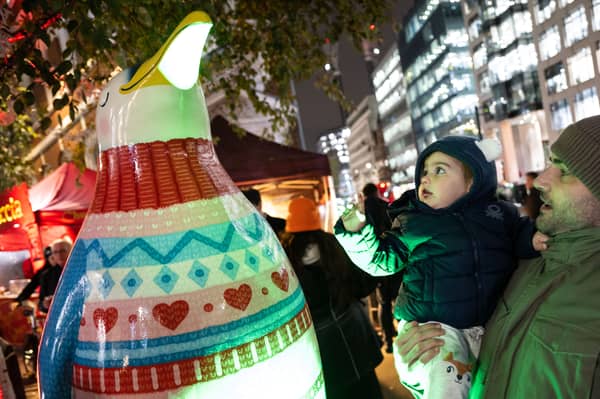Carlos Navarro and his son Carlos, aged 22 months, at the launch of the Fleet Street Quarter Penguin Parade in London