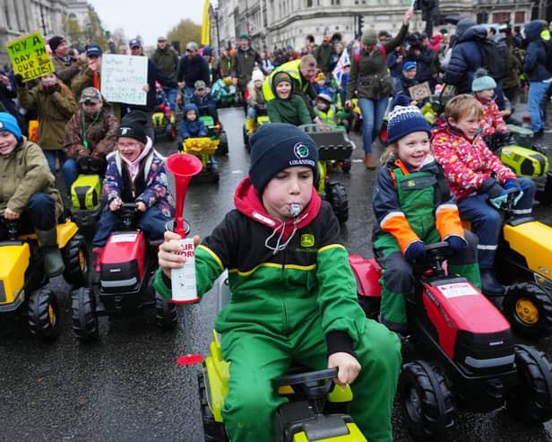 Young guns ride toy tractors through Parliament Square 