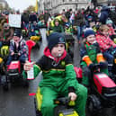 Young guns ride toy tractors through Parliament Square 