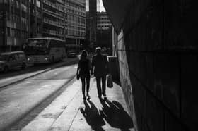 A couple walks down the street hand in hand, in London