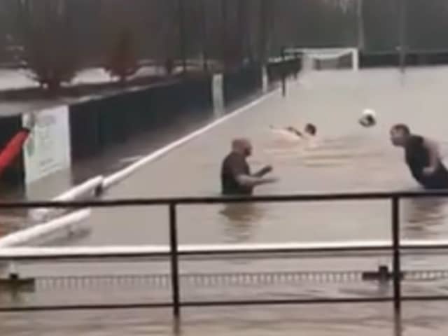 Lydney Town AFC players go swimming on their pitch.
