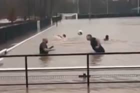 Lydney Town AFC players go swimming on their pitch.
