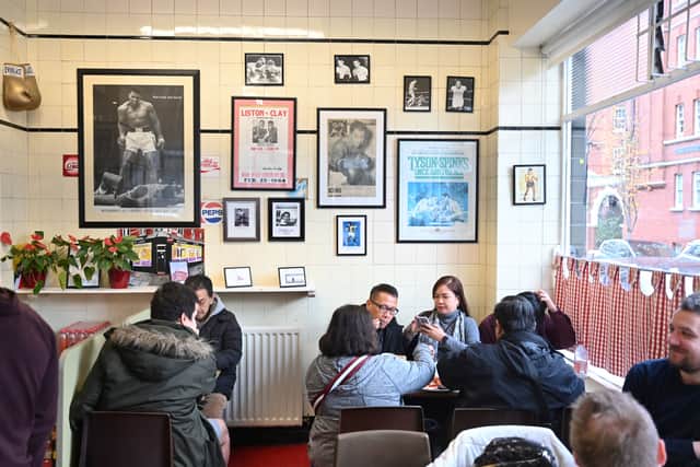 People have a traditional English breakfast at Regency Cafe in London