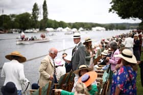 Spectators watch a race on the River Thames at the Henley Royal Regatta in Henley-on-Thames, west of London