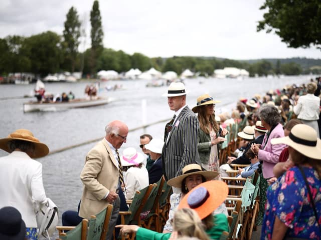 Spectators watch a race on the River Thames at the Henley Royal Regatta in Henley-on-Thames, west of London
