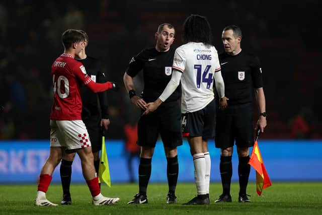 Referee Peter Bankes speaks with Tahith Chong of Luton Town after the Sky Bet Championship match between Bristol City FC and Luton Town FC at Ashton Gate on December 26, 2024