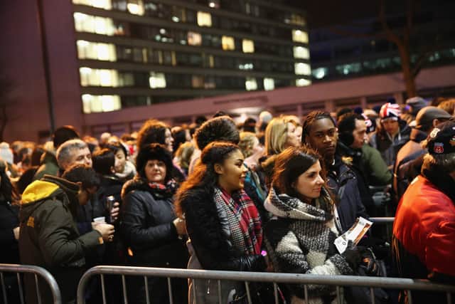 Ticket holders line up as they wait for access to enter Westminster Bridge for New Year firework celebrations
