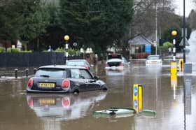 Cars stranded in deep water due to flooding in Stockport.