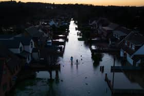 An aerial view shows floodwater surrounding homes and houses on a residential street in Wraysbury, west of London