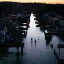 An aerial view shows floodwater surrounding homes and houses on a residential street in Wraysbury, west of London