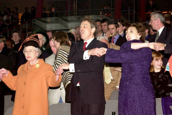 Queen Elizabeth II, Tony Blair, and his wife Cherie Blair during the Millenium New Year celebrations on December 31, 1999 at the Millennium Dome