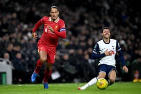 Brennan Johnson of Tottenham Hotspur goes down as he runs for the ball under pressure from Virgil van Dijk of Liverpool during the Carabao Cup Semi Final First Leg match between Tottenham Hotspur and Liverpool at Tottenham Hotspur Stadium on January 08, 2025 in London, England. 