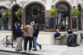 Students enjoy a drink outside the George IV pub opposite the LSE campus 