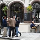 Students enjoy a drink outside the George IV pub opposite the LSE campus 