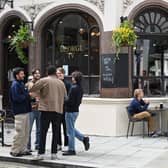Students enjoy a drink outside the George IV pub opposite the LSE campus 