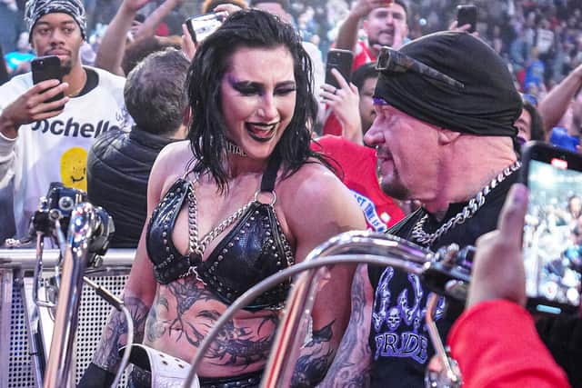 Rhea Ripley celebrates winning the Women's World Championship on the debut episode of WWE Raw on Netflix last week, alongside a cameo appearance from WWE great The Undertaker.