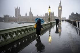 Commuters are battered by strong winds as they cross Westminster Bridge this morning (Jan 24 2025) 