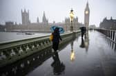Commuters are battered by strong winds as they cross Westminster Bridge this morning (Jan 24 2025) 