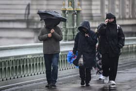 Commuters brave the elements in London this morning