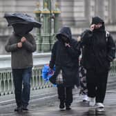 Commuters brave the elements in London this morning
