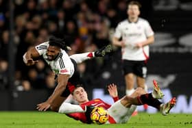 Adama Traore is challenged by Lisandro Martinez.