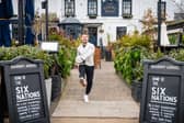 Former England rugby international Danny Care kicking a ball "into space" from outside the Greene King sport pub The Barmy Arms in Twickenham