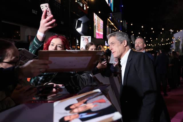 Hugh Grant charmed fans on the pink carpet