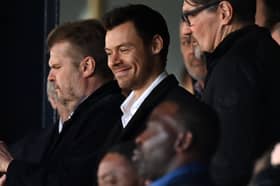 British singer Harry Styles takes his seat for the English Premier League football match between Luton Town and Manchester United at Kenilworth Road in Luton, north of London