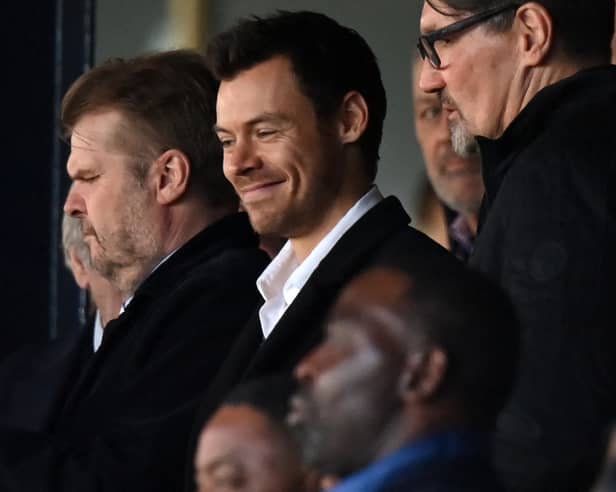 British singer Harry Styles takes his seat for the English Premier League football match between Luton Town and Manchester United at Kenilworth Road in Luton, north of London