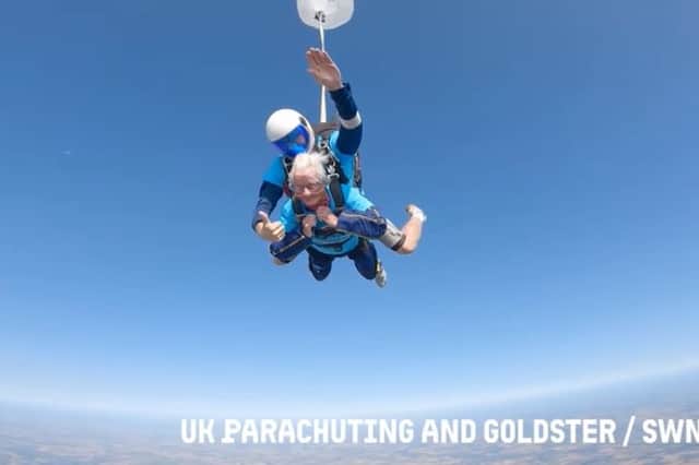 A 102-year-old lady skydiving with an instructor