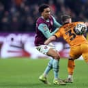 Bashir Humphreys of Burnley tackles Joe Gelhardt of Hull City during the Sky Bet Championship match between Burnley FC and Hull City AFC at Turf Moor on February 12, 2025 in Burnley, England