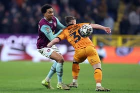 Bashir Humphreys of Burnley tackles Joe Gelhardt of Hull City during the Sky Bet Championship match between Burnley FC and Hull City AFC at Turf Moor on February 12, 2025 in Burnley, England
