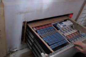 Criminals had built a secret room behind a fake radiator which hid a deep drawer full of illegal tobacco products. 