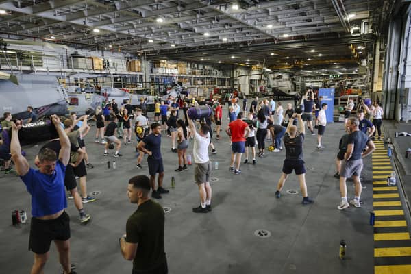 Here are all the details about the Royal Navy's Pre-Joining fitness test, and how you can beat it. Pictured are HMS Queen Elizabeth's ship's company take part in circuits in the hangar.