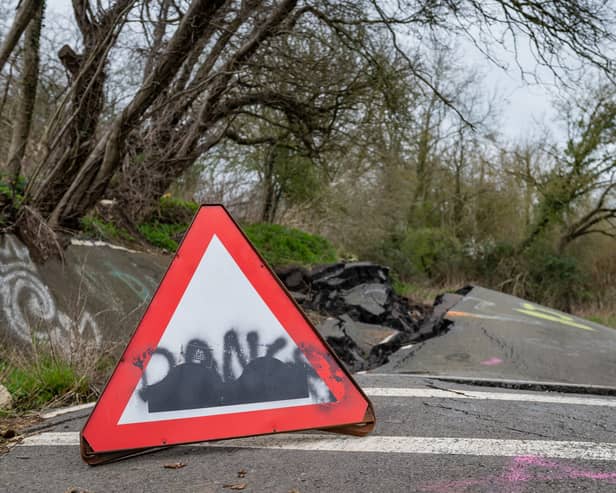 A road left so badly damaged by a landslip it was closed to cars can't be fixed properly - as it's still moving a YEAR later.  