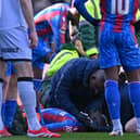 Jean-Philippe Mateta receives treatment on the turf at Selhurst Park.